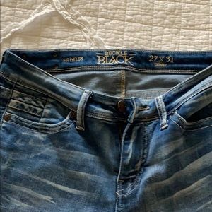 Buckle black skinny jeans